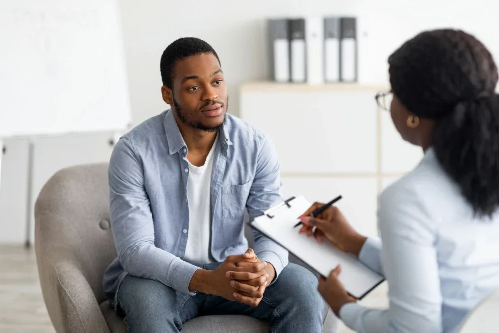 Man in an individual therapy session while the counselor takes notes in Memphis, Tennessee. Man in an individual therapy session while the counselor takes notes in Memphis, Tennessee.