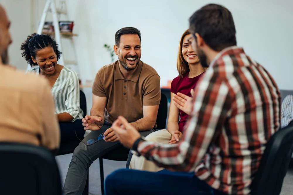 group of smiling people in recovery for addiction