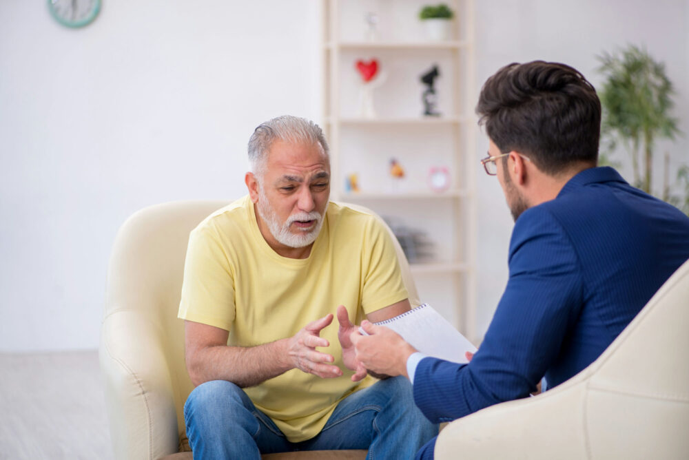 Elderly man talking with his counselor during a meth addiction treatment session in Memphis, Tennessee