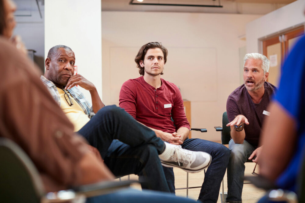 Group of men in a therapy session discussing strategies for meth addiction treatment in Memphis, Tennessee