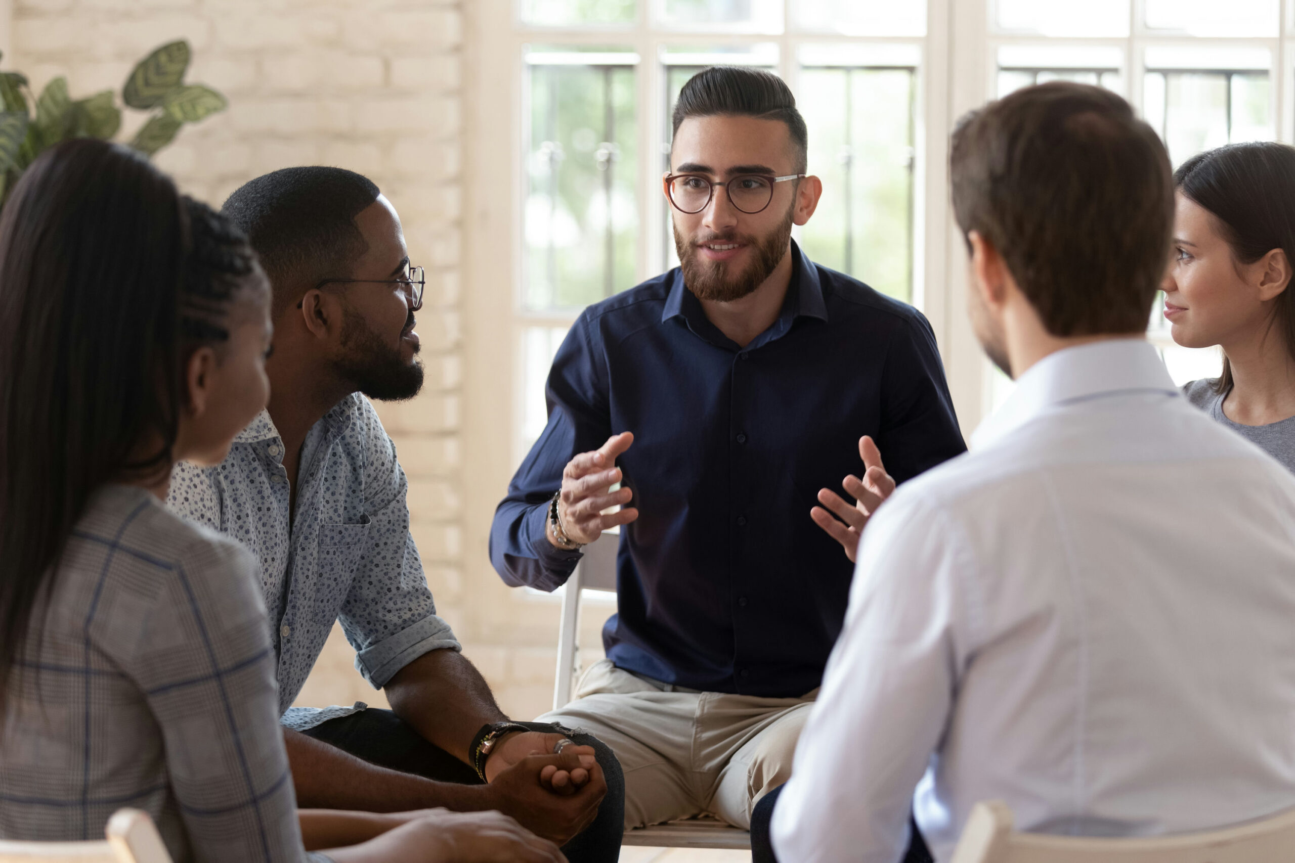 Individuals listening to their therapist about addiction treatment services in Memphis, Tennessee