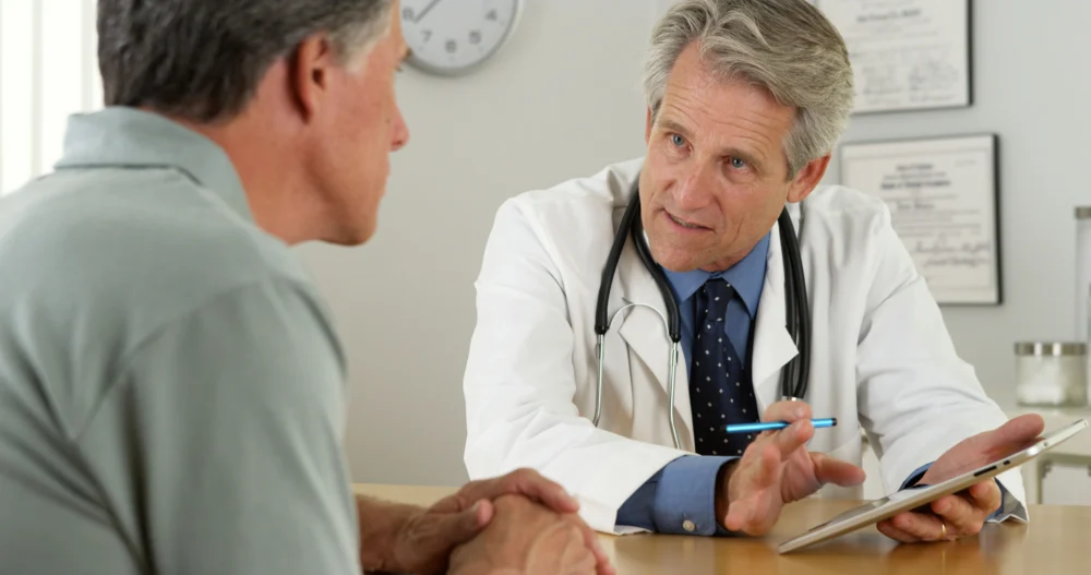 doctor advising elderly man about safe heroin detox options