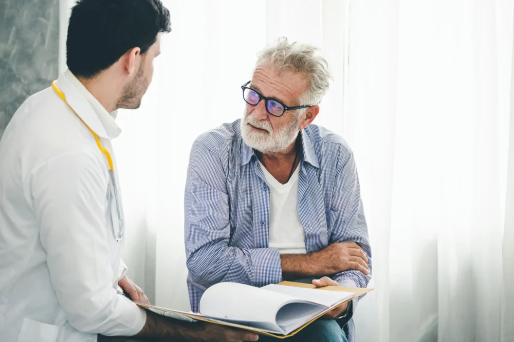 elderly man talks with therapist about starting heroin detox